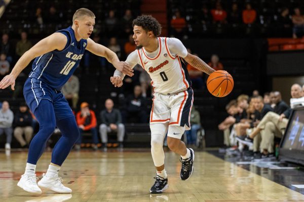 Jordan Pope (0) takes on a defender as he looks to make a play in Gill Coliseum against the UC Davis Aggies on Nov. 30. The Beavers pulled off a 71-59 win at the end of regulation.