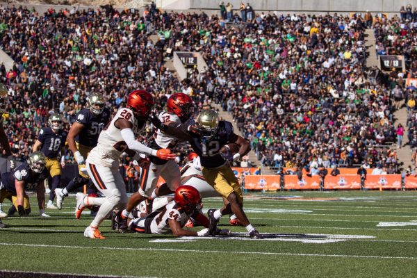 Oregon State defenders wrap up a Notre Dame player in the Tony the Tiger Sun Bowl on Dec. 29, 2023. The Beavers fell 40-8.