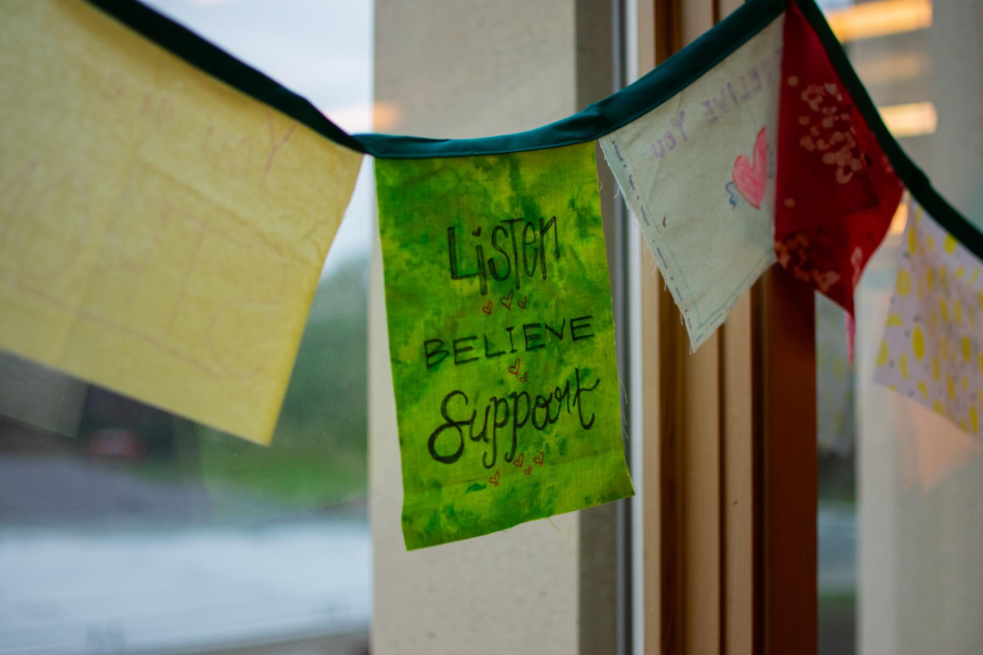 Handmade flags hang in the windows of the CAPE office in the Oregon State University Student Experience Center in Corvallis, Oregon on Dec 13, 2023.