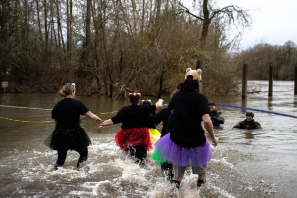 Participants run into the lake at the polar plunge on the Willamette Boat
Landing at Crystal Lake Sports Fields on February 17th, 2024.