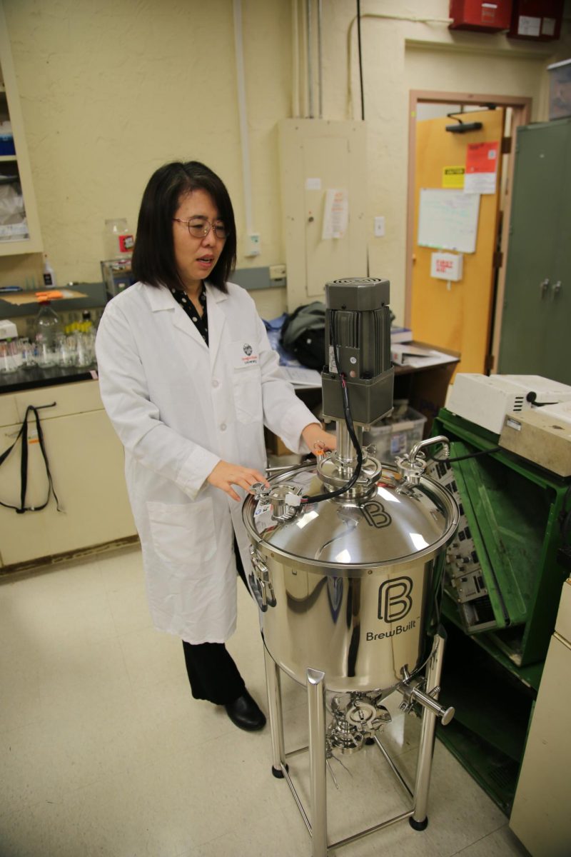 Hong Liu shows a reactor used in her wastewater energy lab at Oregon State University on Jan. 26.