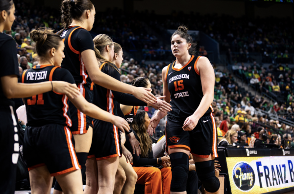 Oregon State Women’s Basketball players high five their teammate Raegan Beers (15) on the sidelines at Matthew Knight Arena in Eugene on Feb. 4.
