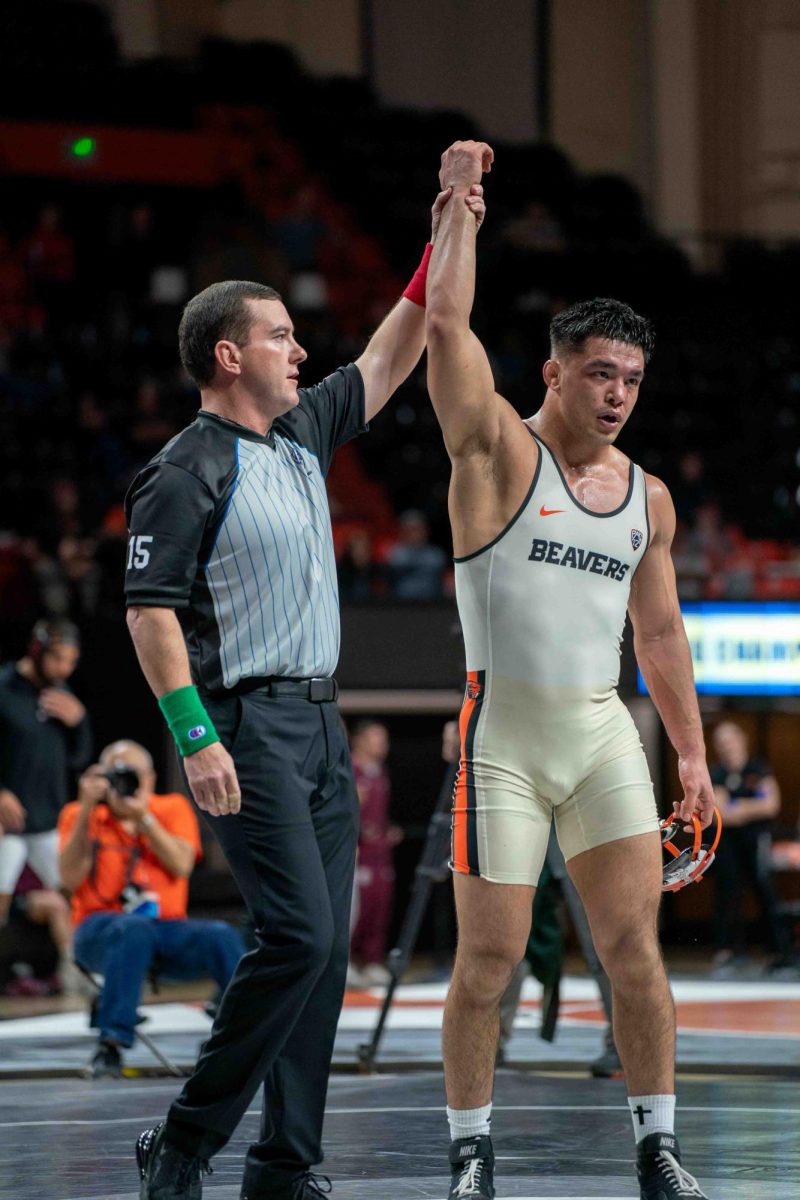 The referee raises Trey Munoz hand as the winner of his match during the Pac-12 Wrestling Championship at Gill Coliseum in Corvallis on Sunday.