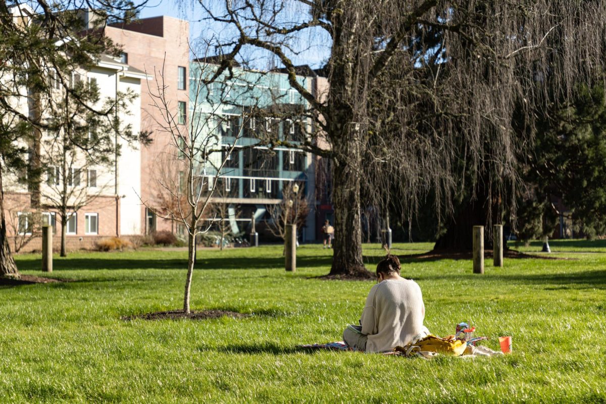 A student studies in the grass near ILLC on Saturday, Feb. 10, 2024.

