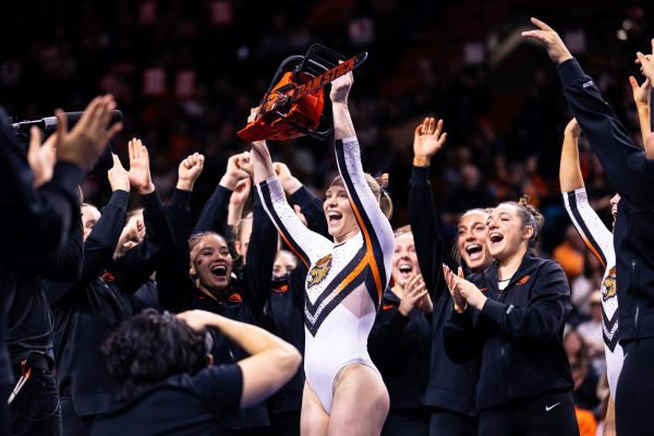 Jade Carey proudly holds up the chainsaw after a near perfect score on her floor exercise on March 1, at Gill Coliseum in Corvallis, Oregon. Carey is surrounded by her supporting teammates as Beaver fans’ cheers roar through Gill Coliseum.