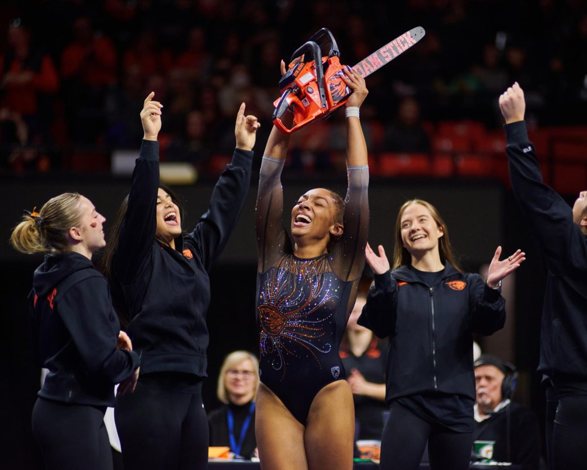 Oregon State University gymnast and Senior Ariana Young celebrates after completing her floor routine in a meet against the University of Washington on Friday in her final meet at Gill Coliseum. 
