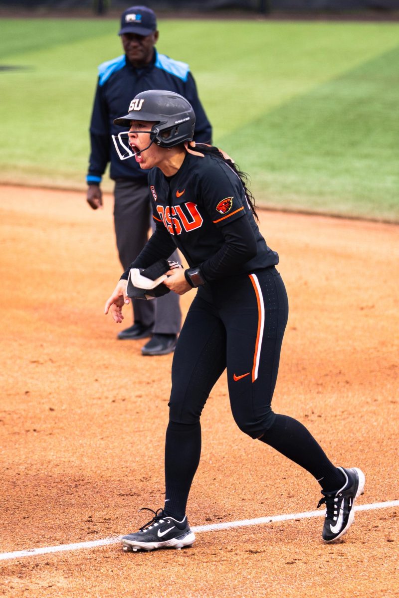 Paige Doerr (14) shows excitement after making it to first base at Kelly Field on March 9 in Corvallis, Oregon.
