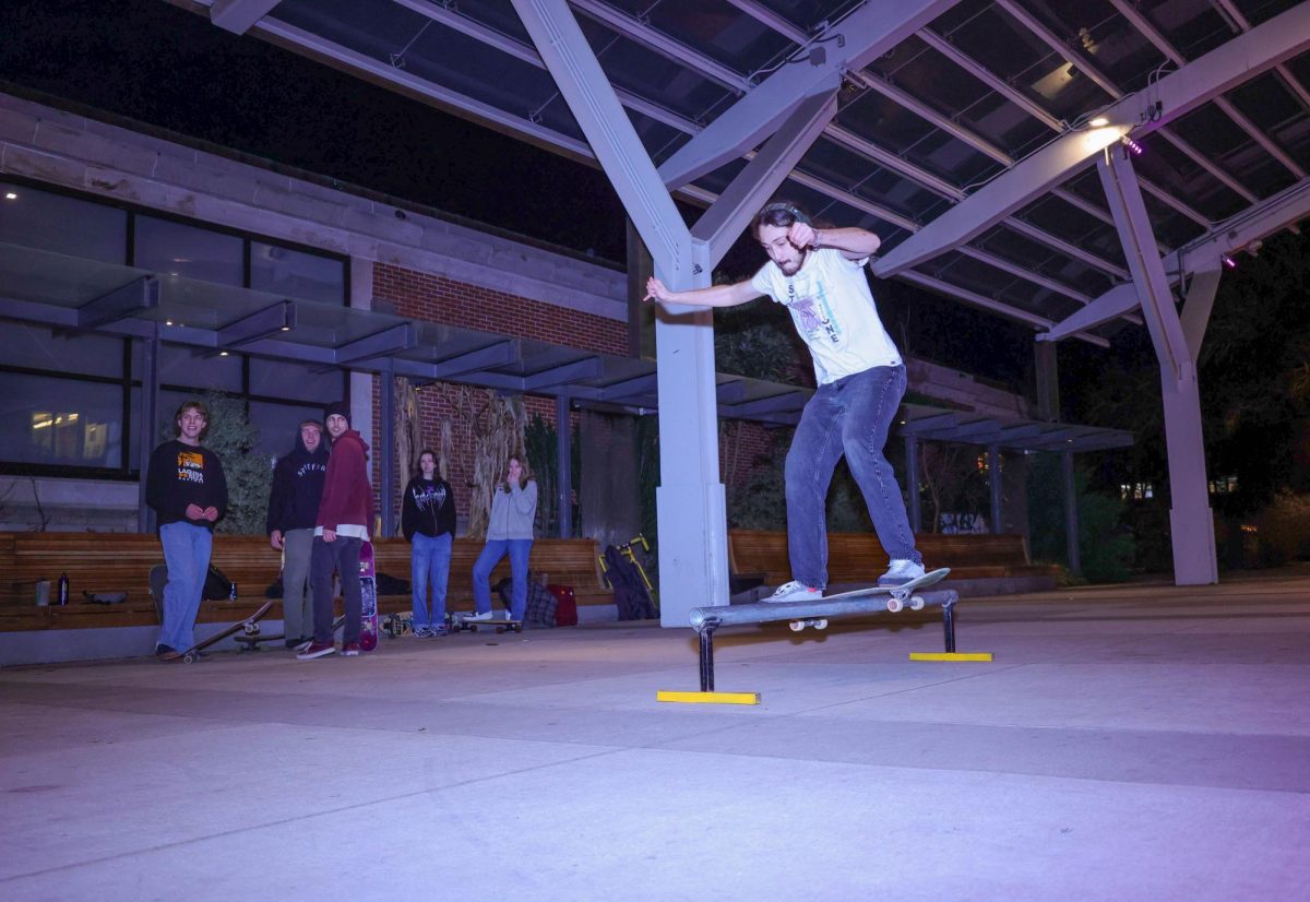 A Skate Club member grinds a homemade rail in front of the SEC on Wednesday, Feb. 7 in the SEC Plaza.