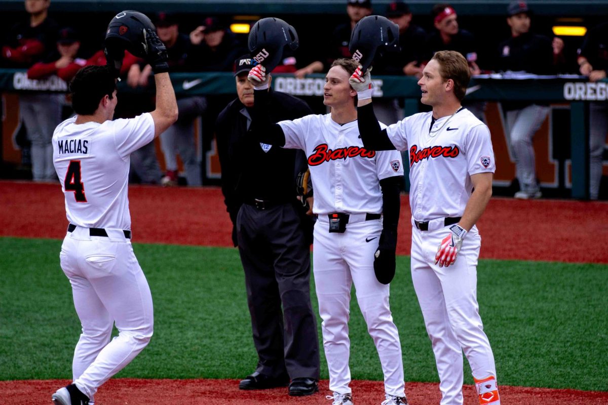 OSU INF/OF Dallas Macias bumps helmets with his teammates to celebrate his home run against the Stanford Cardinals at Goss Stadium in Corvallis on April 12.
