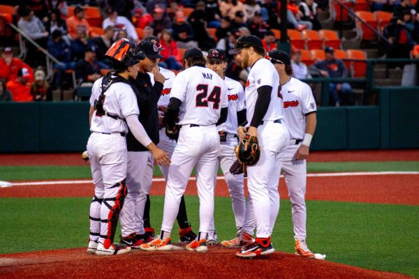 OSU BB team has a meeting on the pitching mound against the Stanford Cardinals at Goss Stadium in Corvallis OR on April 12 2024