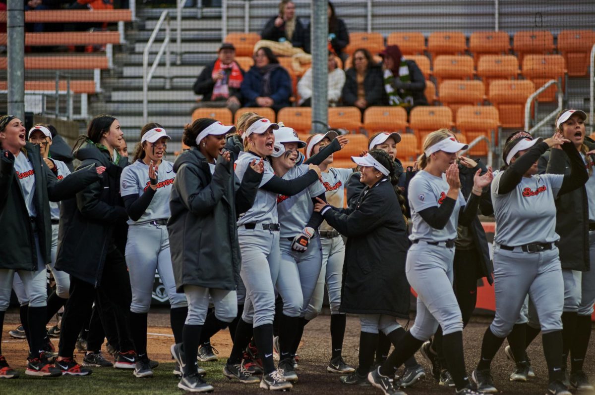 Oregon State University softball players cheer after teammate Madyson Clark hit a home run at Kelly Field on Friday, April 26. 