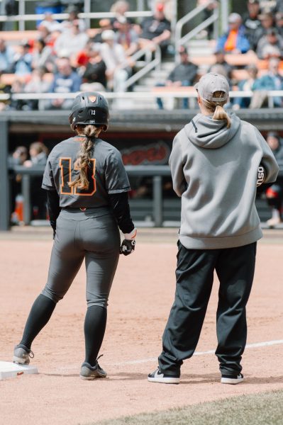 Kaylee Oh (#13) stands next to Head Coach Laura Berg in OSU’s game against University of
Utah at Kelly Field on April 28, 2024.