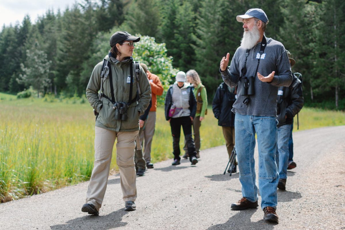 Josée Rousseau (left) and David Ehlers discuss different bird species during a bird walk event at J2E Tree Farm on May 19, 2024.