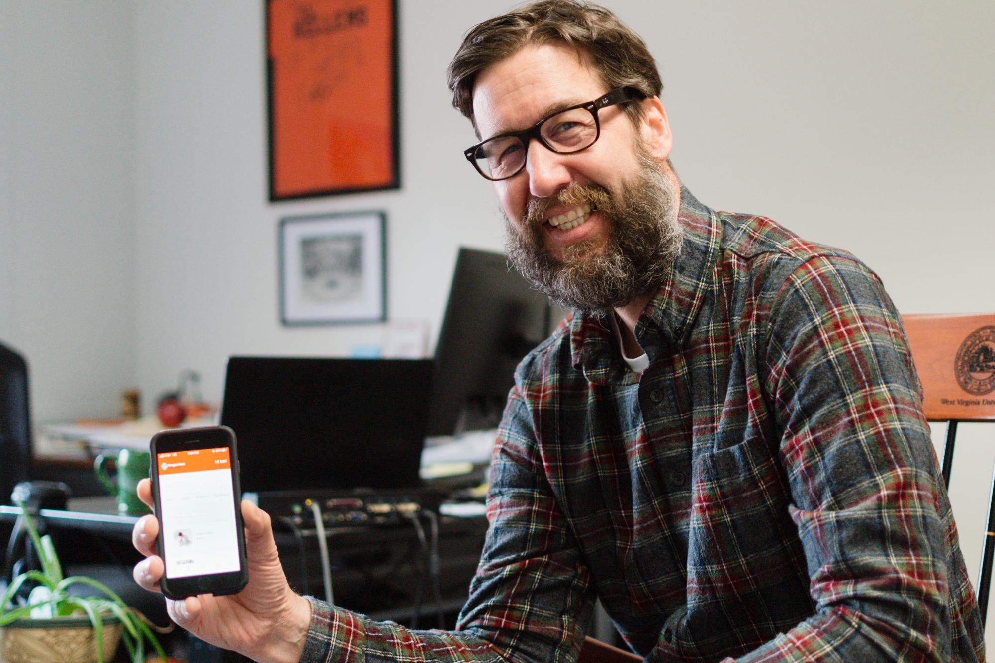 Dr. Ian Kellems (he/him), Executive Director and Licensed Psychologist of Counseling & Psychological Services, demonstrates how to use the app “Anytime Anywhere” in Snell Hall on April 15, 2024. Anytime Anywhere was developed to expand mental health services to students including free and confidential counseling at any time of day, from anywhere in the world, at any day of the year.
