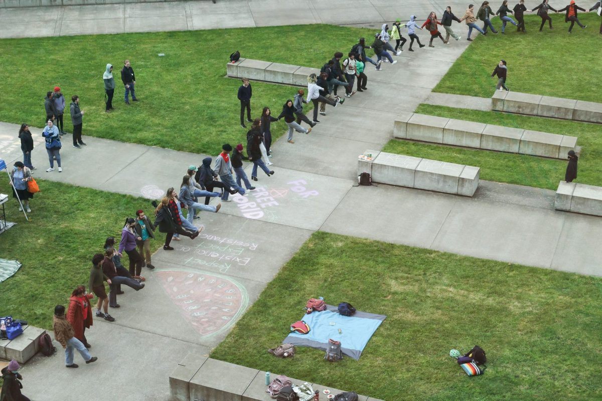 Protesters join hands and dance in a circle spanning hundreds of feet in support of Palestine at Oregon State University, on May 1, in Corvallis OR.