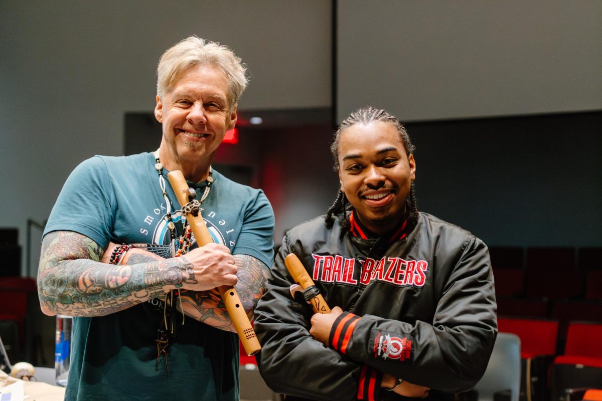 Senior Instructor Jan Michael Looking Wolf Reibach (left) and student Jimmy Wilson smile with their Native American flutes after class at the Learning Innovation Center on May 21, 2024.