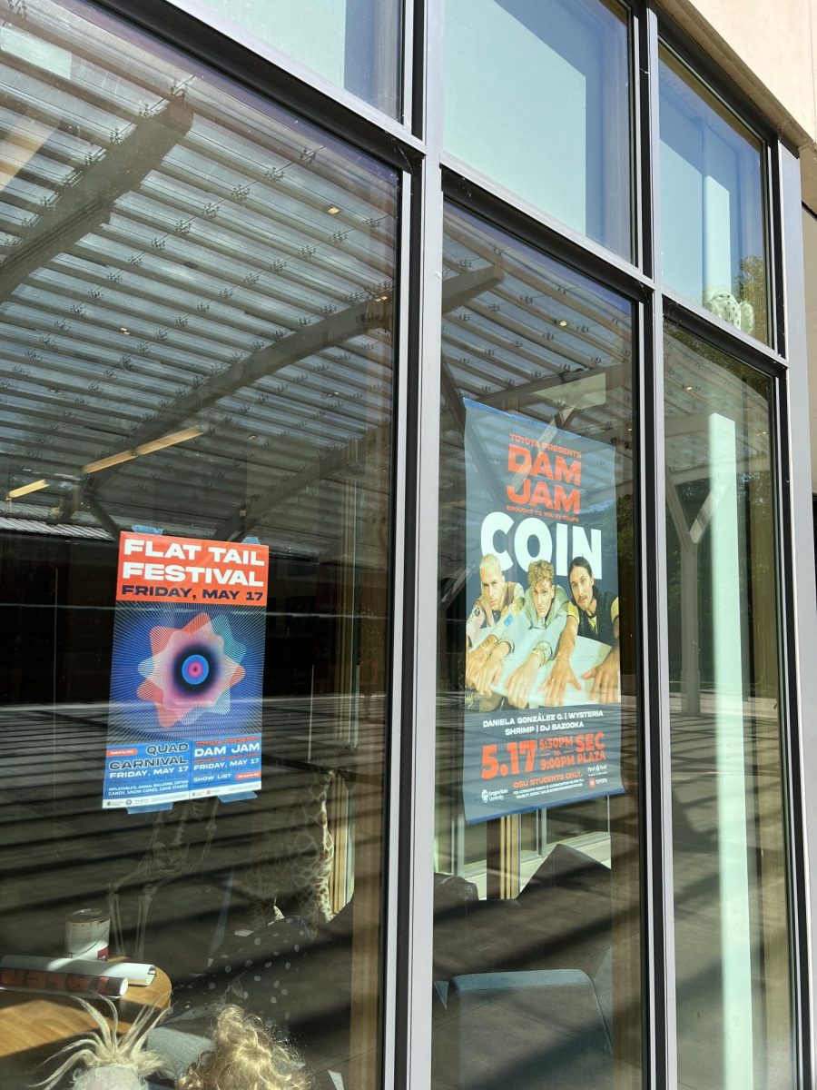 Flat Tail Festival posters hang in the Student Experience Center plaza on May 17, where Dam Jam was set to take place that evening. 