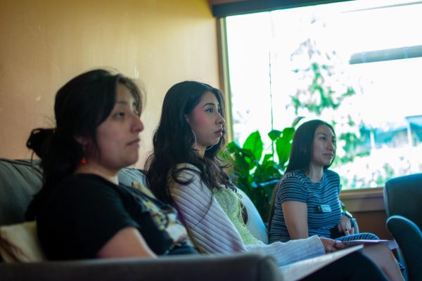 Amanda Puitiza, Michelle Lira Licona, and Angelica Hernandez listen to the presentation during the Managing Stress bilingual workshop at Central Cultural Cesar Chavez, April 19. 