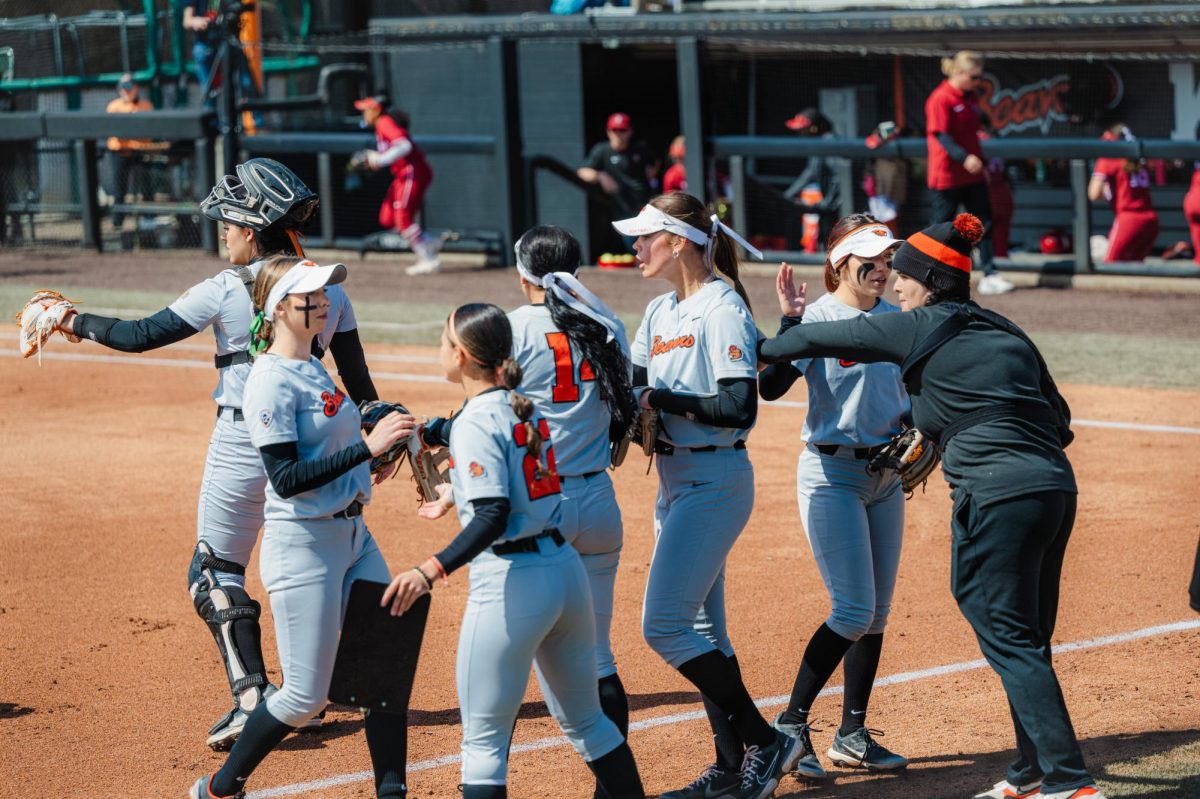 On April 14, 2024, the OSU Beaver softball team comes together as they switch innings in a game against Stanford at Kelly Field