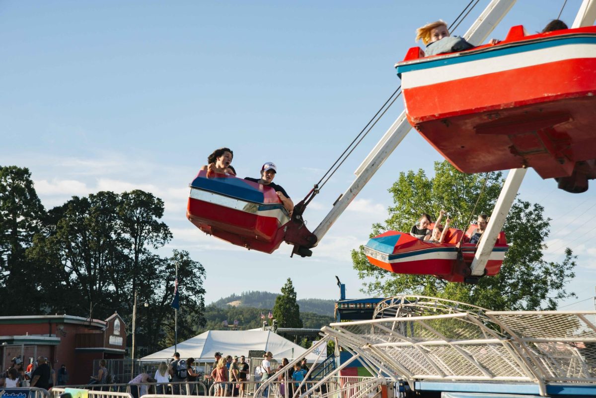 “Visitors ride an amusement park ride at the Benton County Fair in Corvallis on Aug. 4, 2022.” (Jess Hume-Pantuso) 