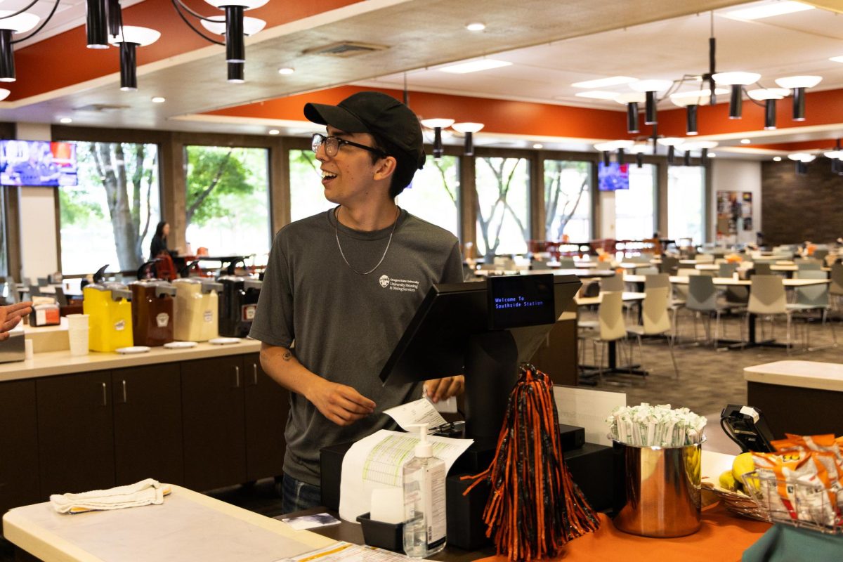 UHDS student worker and junior Civil Engineering Major Michael Bareno-Le prepares to ring up food orders in Arnold Dining Hall on Oregon State campus on Mon, July 29, 2024.