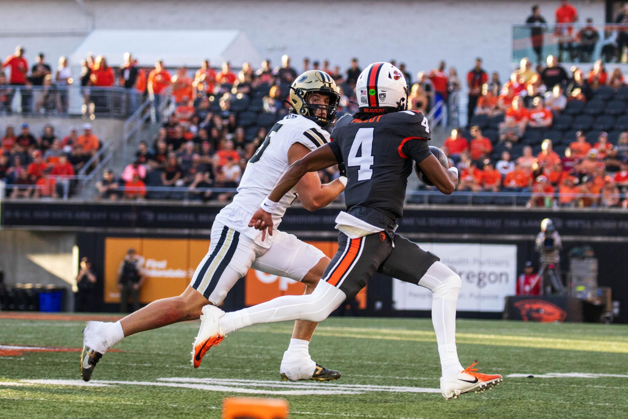 Quarterback Gevani McCoy (4) makes a break towards the end zone in OSU’s game against Purdue in Reser Stadium on Sept 21 in Corvallis.