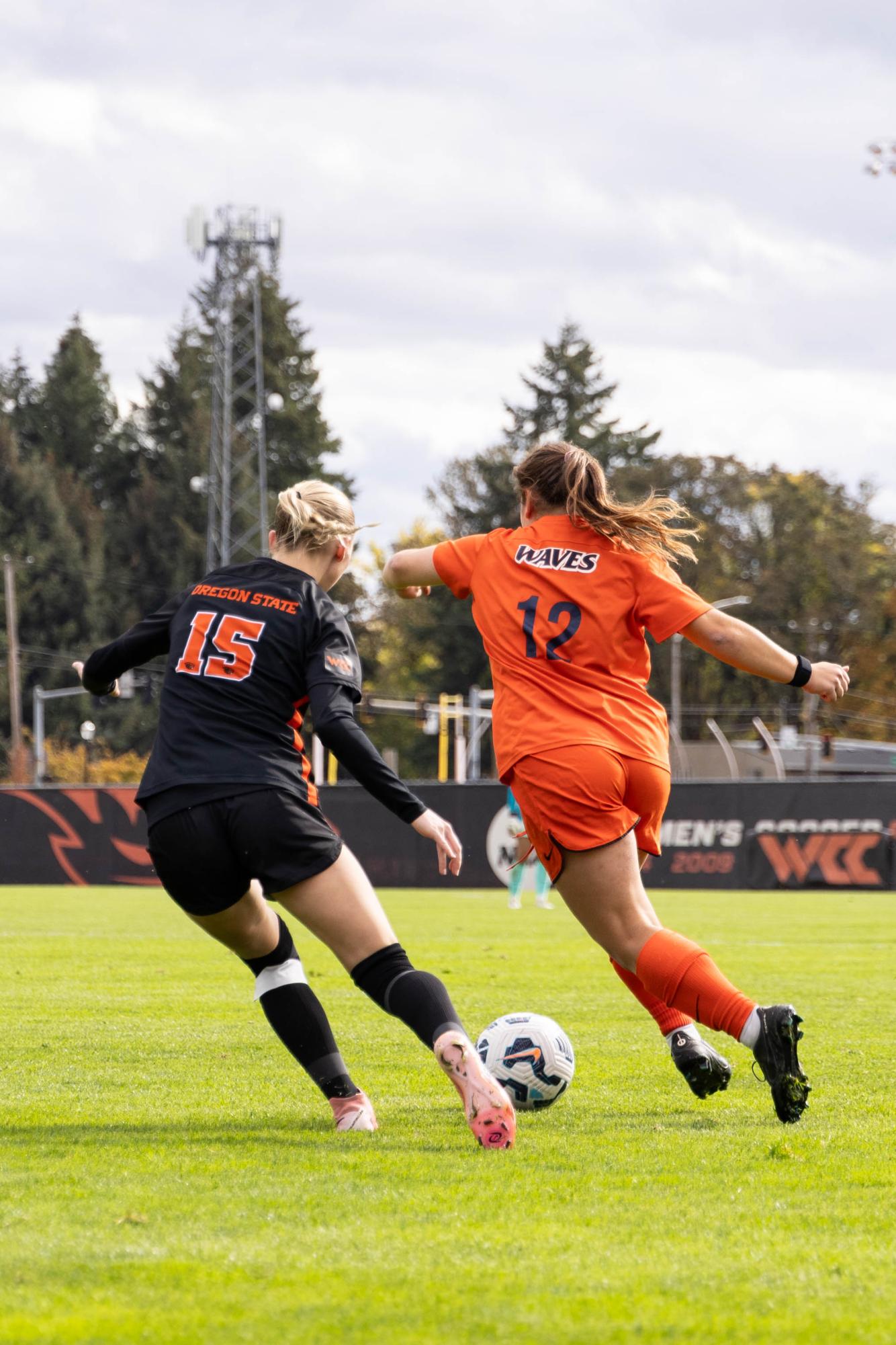 Forward Carly Carraher (#15) defends against Pepperdine midfielder Caroline Coleman (#12) in Oregon State's game against Pepperdine on Oct 26 at Paul Lorenz Field.