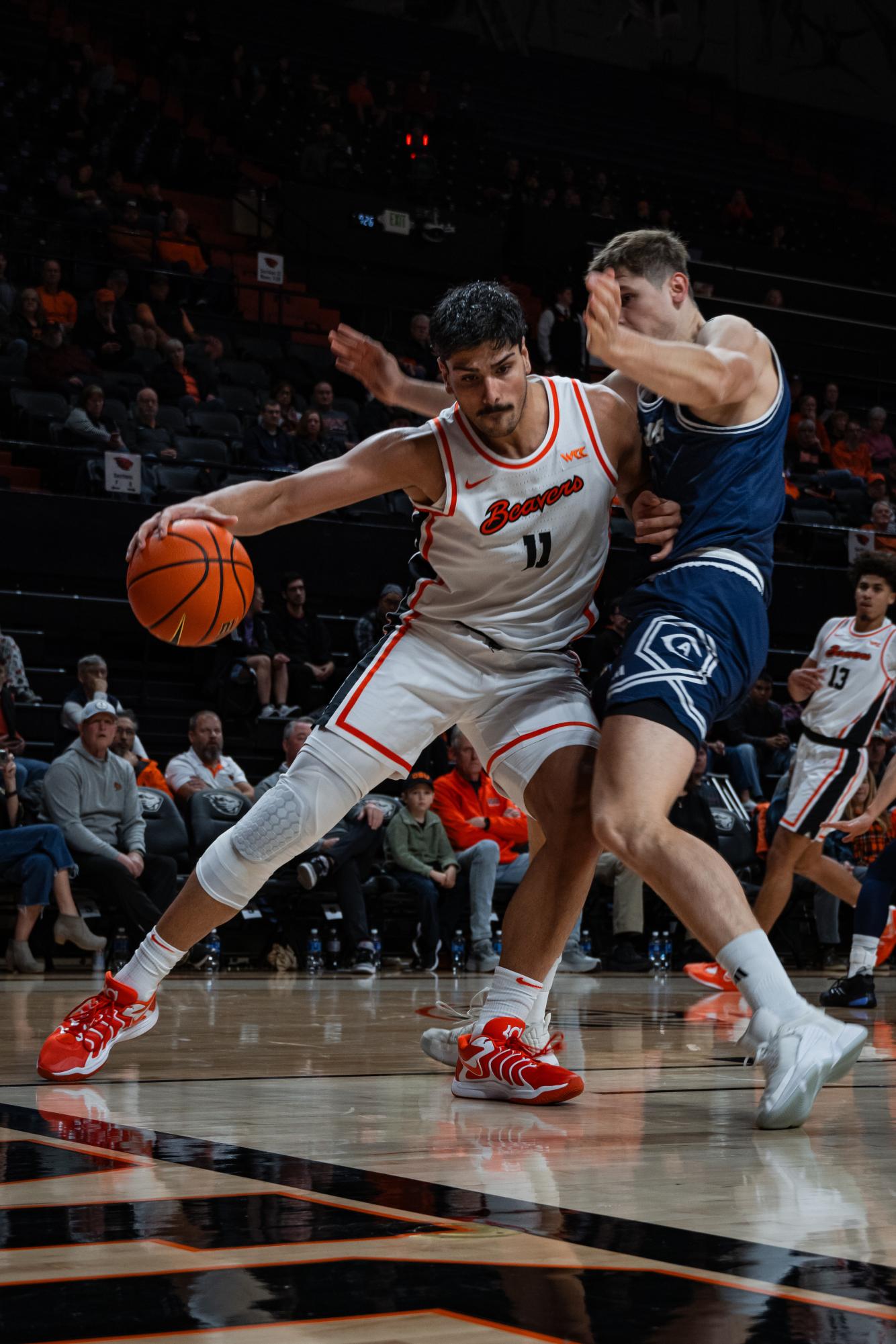 Parsa Fallah bodies his defender as he pushes towards the basket against the UC Davis Aggies in Gill Coliseum on Nov 30 2024.