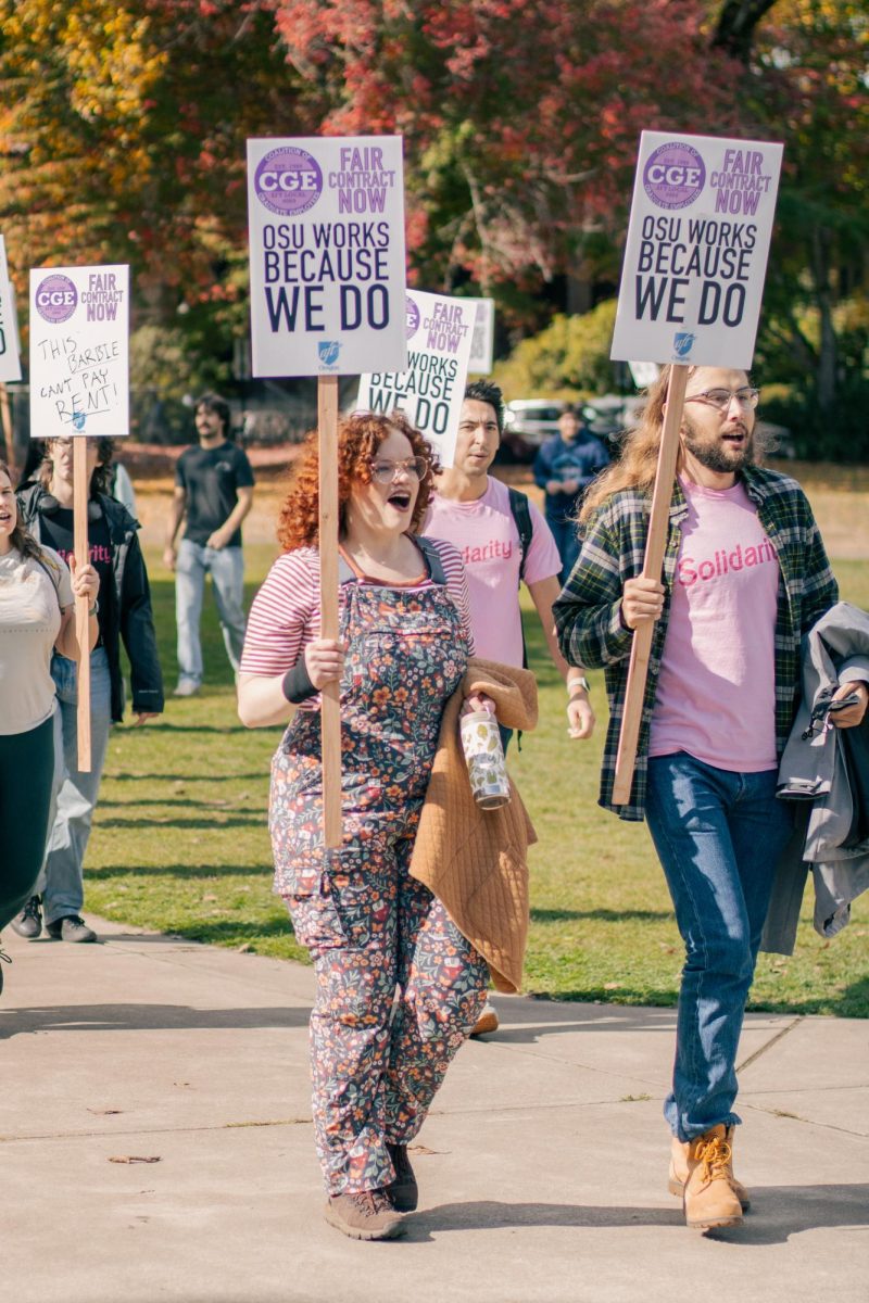 Student protesters hold signs for the Coalition of Graduate Employees at a practice picket at Oregon State University on Oct. 16.