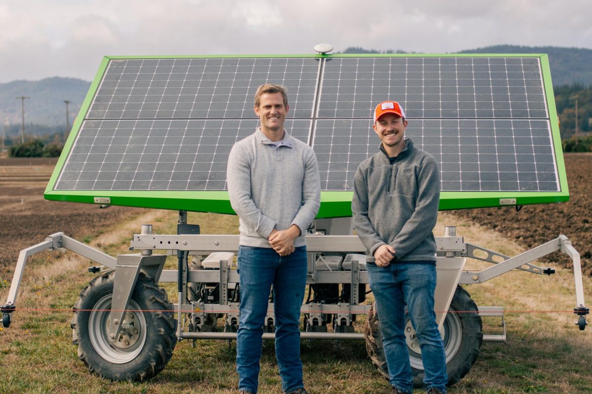 Pete Berry and Andrew Branka stand in front of the FarmDroid at Hyslop Field Research Laboratory on Oct. 21st.