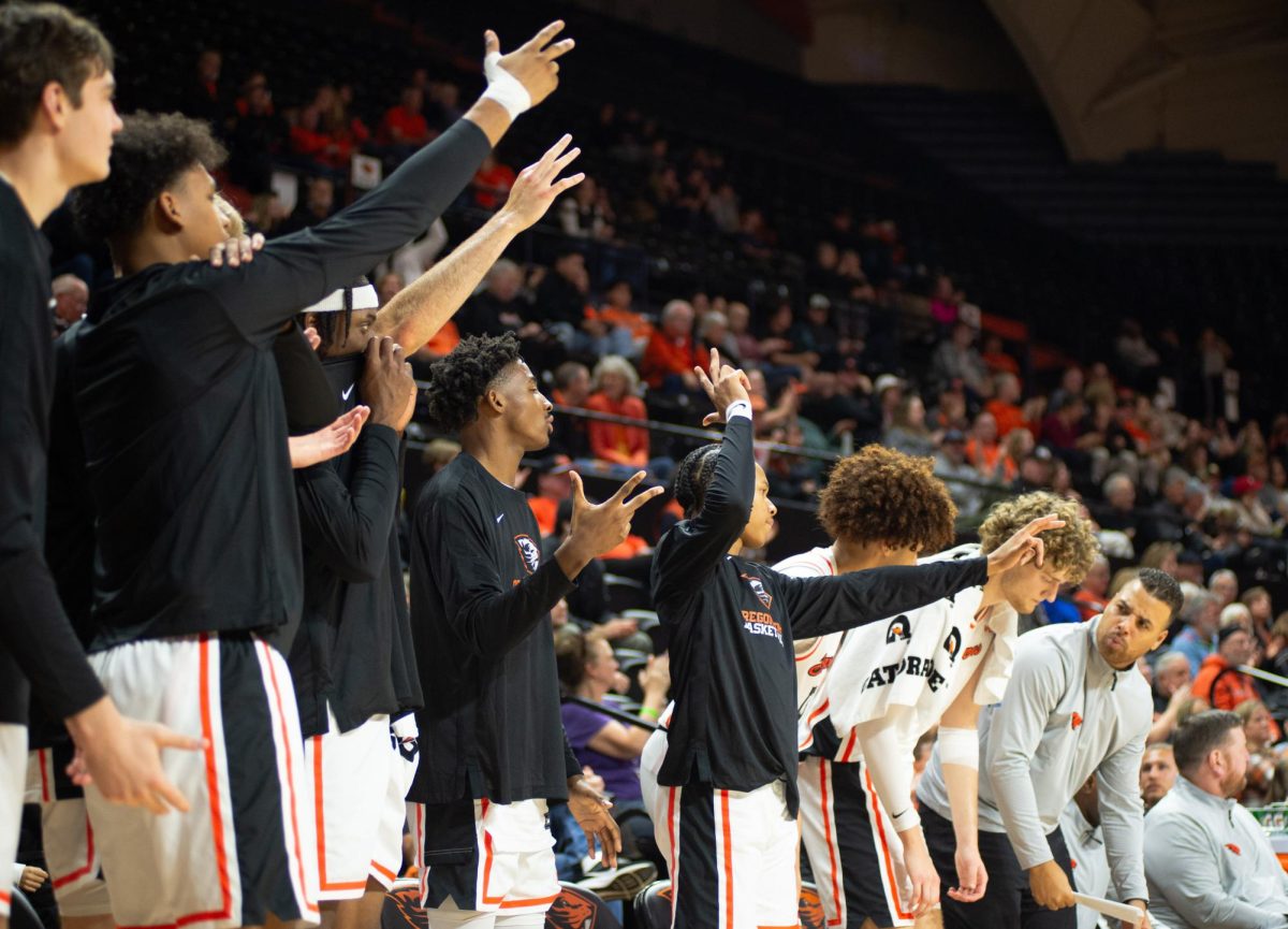 The Beaver bench celebrates a 3-pointer in a decisive win against Weber State in Gill Coliseum on Nov 8, 2024.