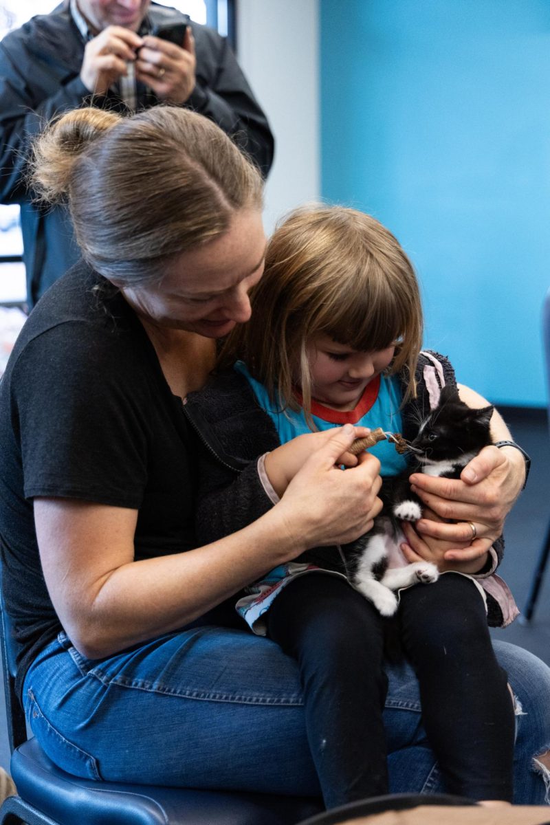 Corvallis resident Shawn Hazboun, left, and her daughter Magnolia meet a kitten available for adoption during Heartland Humane Society’s Caturday Event on Nov. 9 in the Corvallis Community Center. This event included snacks, games and kittens for attendees to meet and befriend.