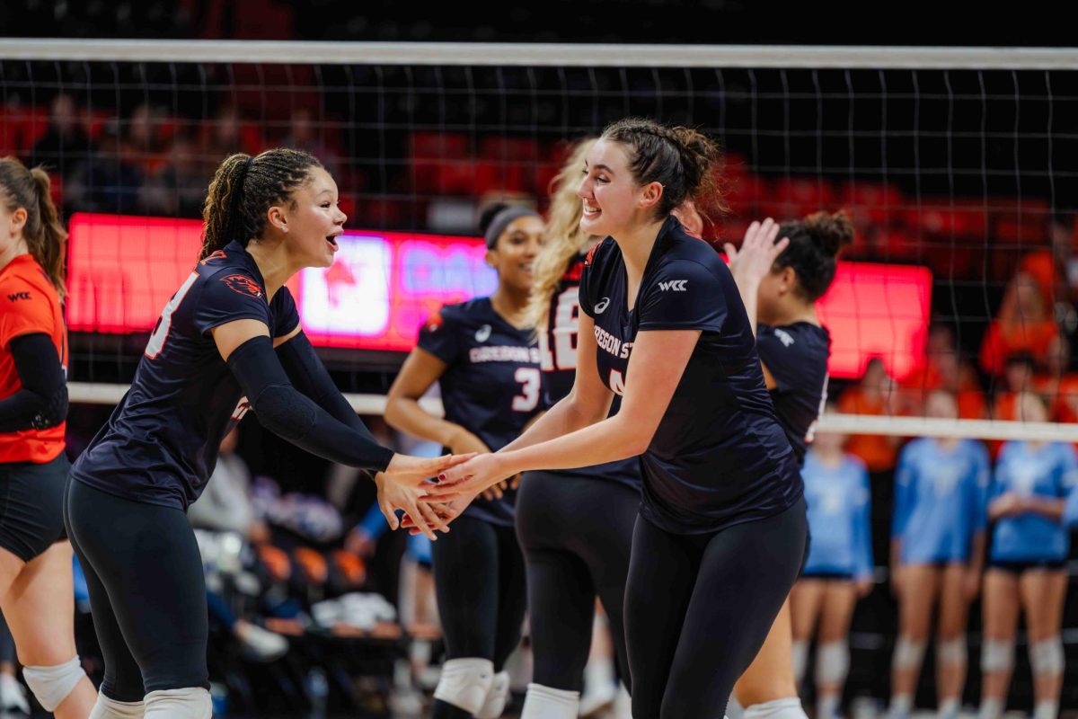 Outsider hitter, Alexix Rodriguez (#23) and opposite, Annika Hester (#4) celebrate after a score for the beavers in a game against San Diego on Nov 16, 2024 in Gill Coliseum