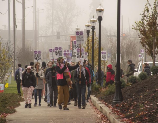 The Coalition of Graduate Employees circles the Kerr Administration building as a bargaining session between CGE and OSU occurs on Dec. 6. The two parties came to tentative agreement Friday.