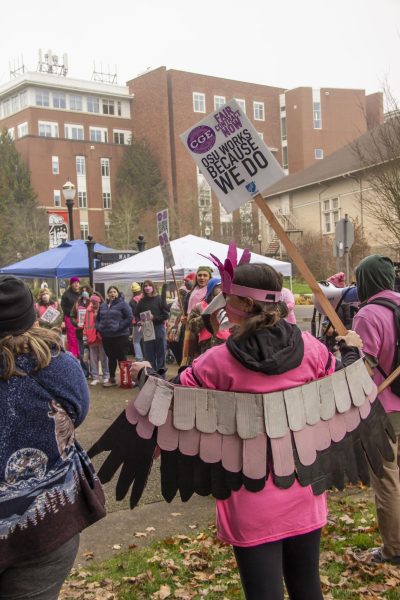 The Coalition of Graduate Employees circles the Kerr Administration building as a bargaining session between CGE and OSU occurs on Dec. 6. The two parties came to tentative agreement Friday.