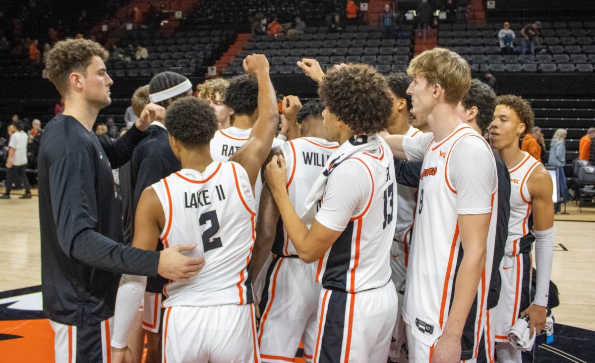 Beavers huddle together to celebrate the victory at 78-62 against the Idaho Vandals in Corvallis Dec. 7.