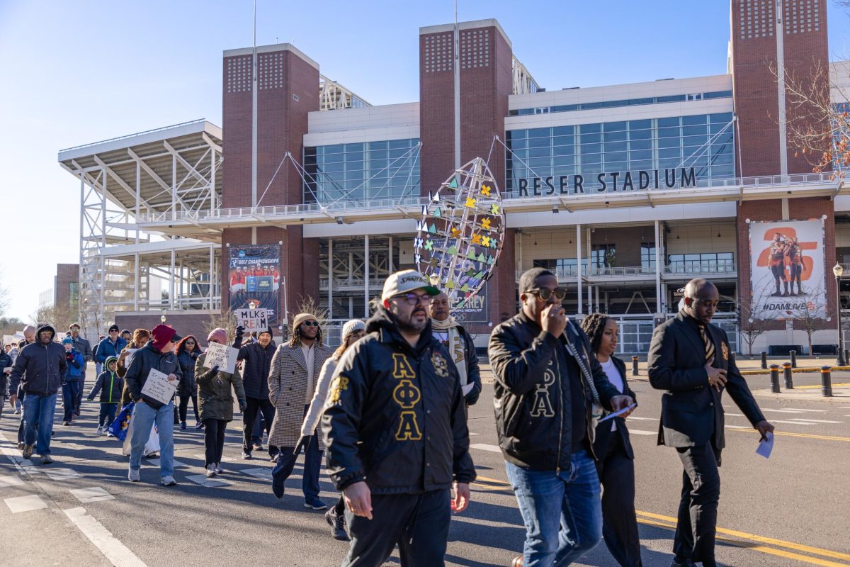 The annual Dr. Martin Luther King Jr. Day Peace March took off from the CH2M Alumni Center, passing Reser Stadium on Jan. 20. Director of the Lonnie B. Harris Black Cultural Center Jamar Bean leads the Peace March singing “This Little Light of Mine”.