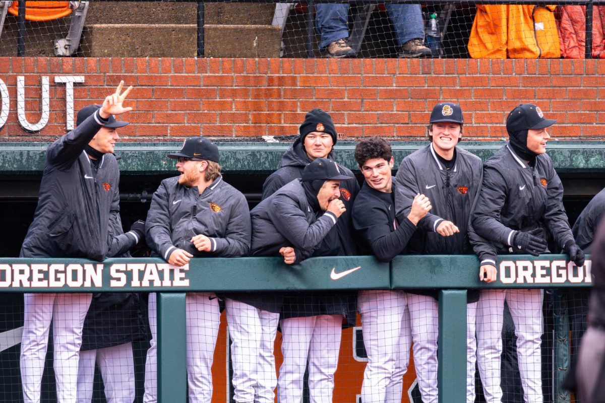 The Oregon State University Baseball teammates cheer in the dugout after a home run Mason Guerra (9) completes a throw out at first base to NDSU player at Goss Stadium at Coleman Field on March 3 in Corvallis, Oregon.