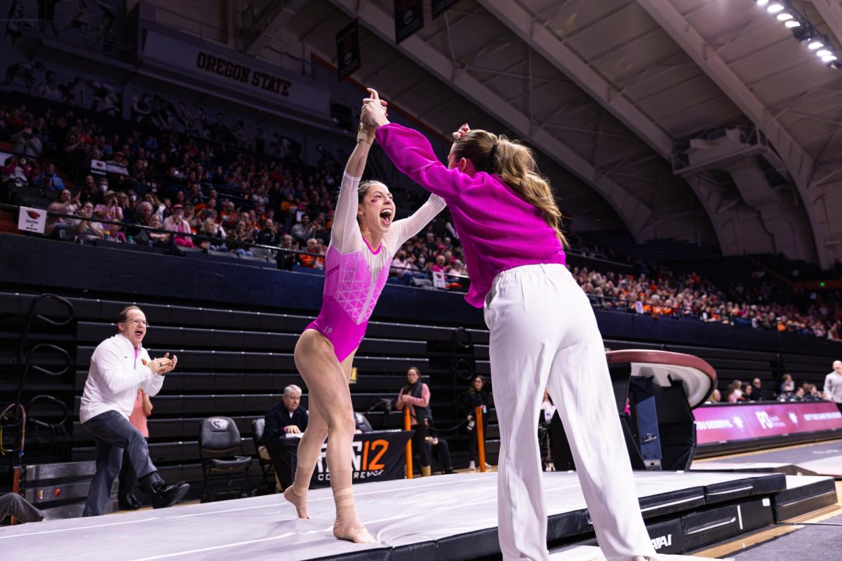 Senior Kaitlin Garcia celebrates after landing on vault, scoring a 9.900 at the triple meet against Washington and Alaska in Gill Coliseum on Feb. 10, 2025. Garcia secured the highest score on vault for the Beavers this meet