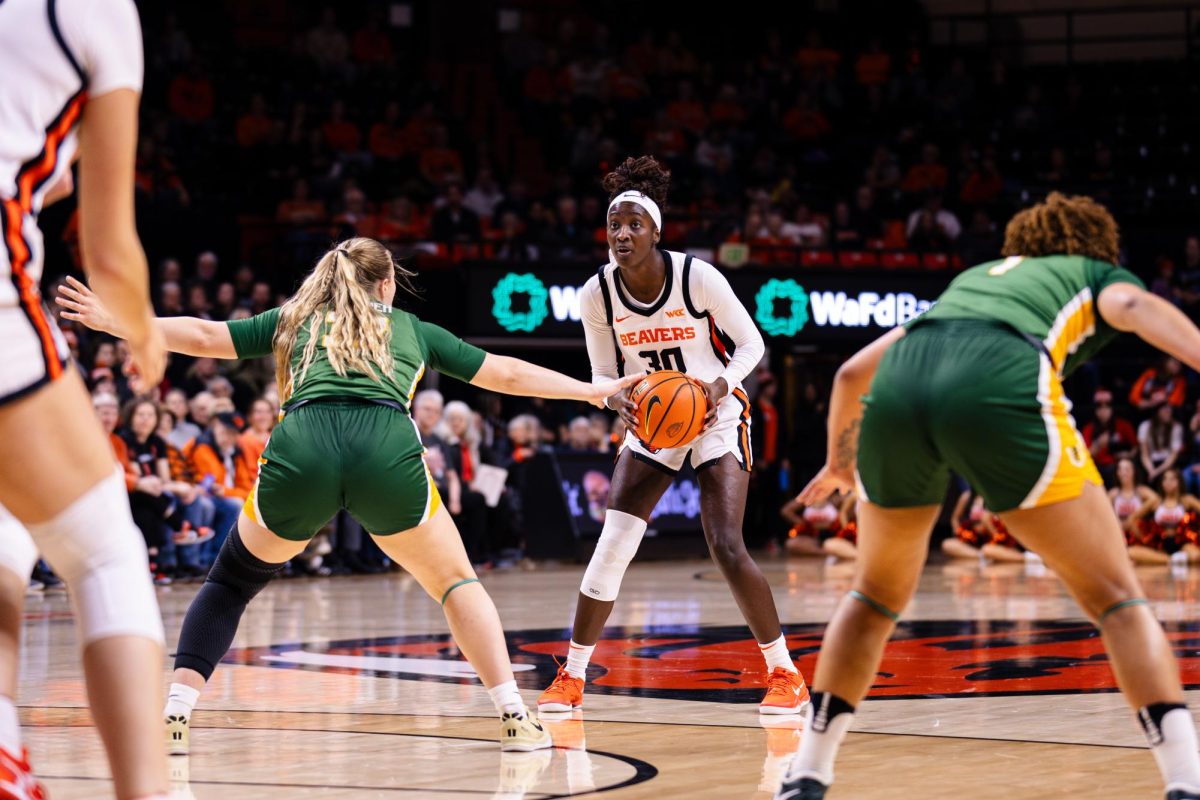 Guard Catarina Ferreira (30) scans the court to pass the ball in Gill Coliseum on Jan. 9, 2025.