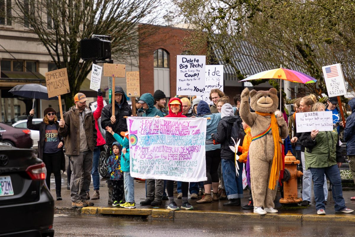 People gather in front of the Benton County Courthouse to protest President Trump and special government employee Elon Musk on Presidents Day. An estimated number of over 250 community members participated.