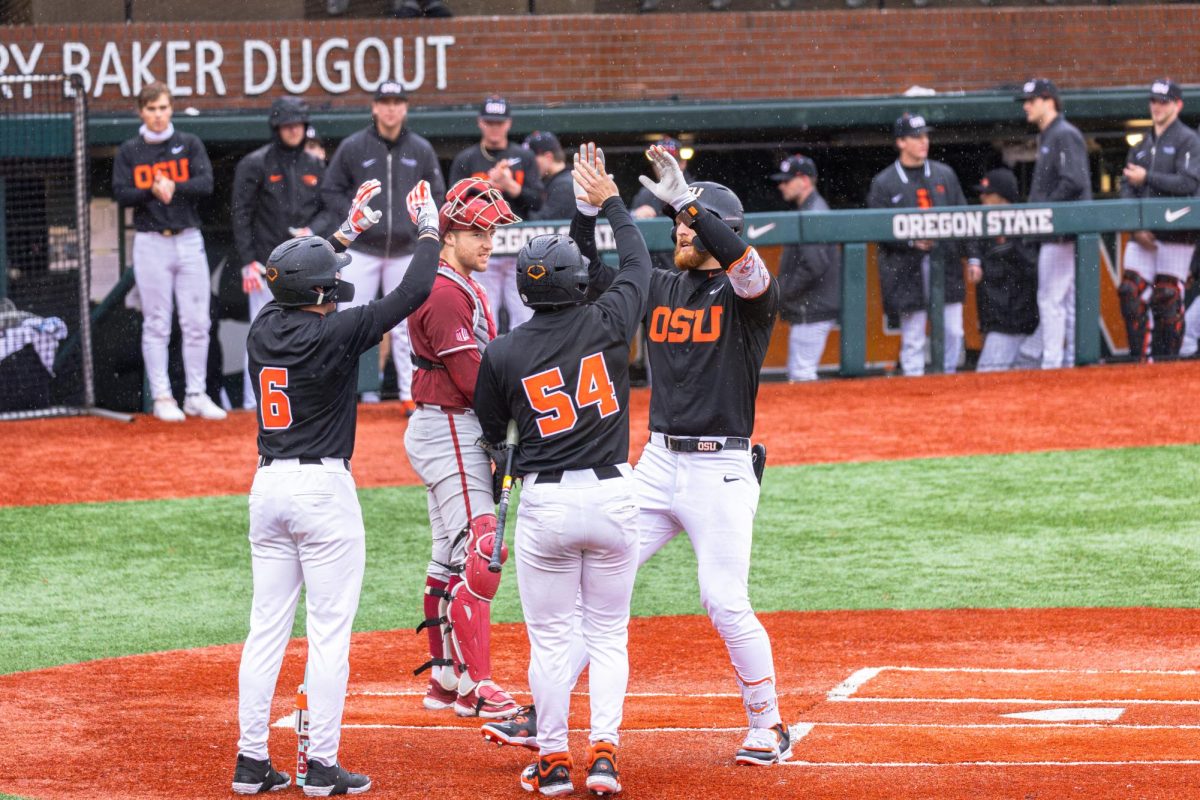 Junior infielder Jacob Krieg (right) celebrates his home run with his fellow Beavers at the home plate on March 12, at Goss Stadium in Corvallis. The Beavers continued their home winning streak in the second game of the two-part series against Washington State University.