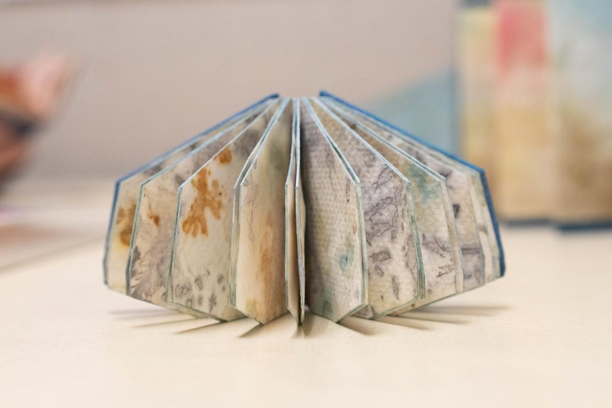 A small handmade book stands on a table on March 15, 2025. Artist Sabra Comins uses recycled, reused, and reclaimed paper for her art.