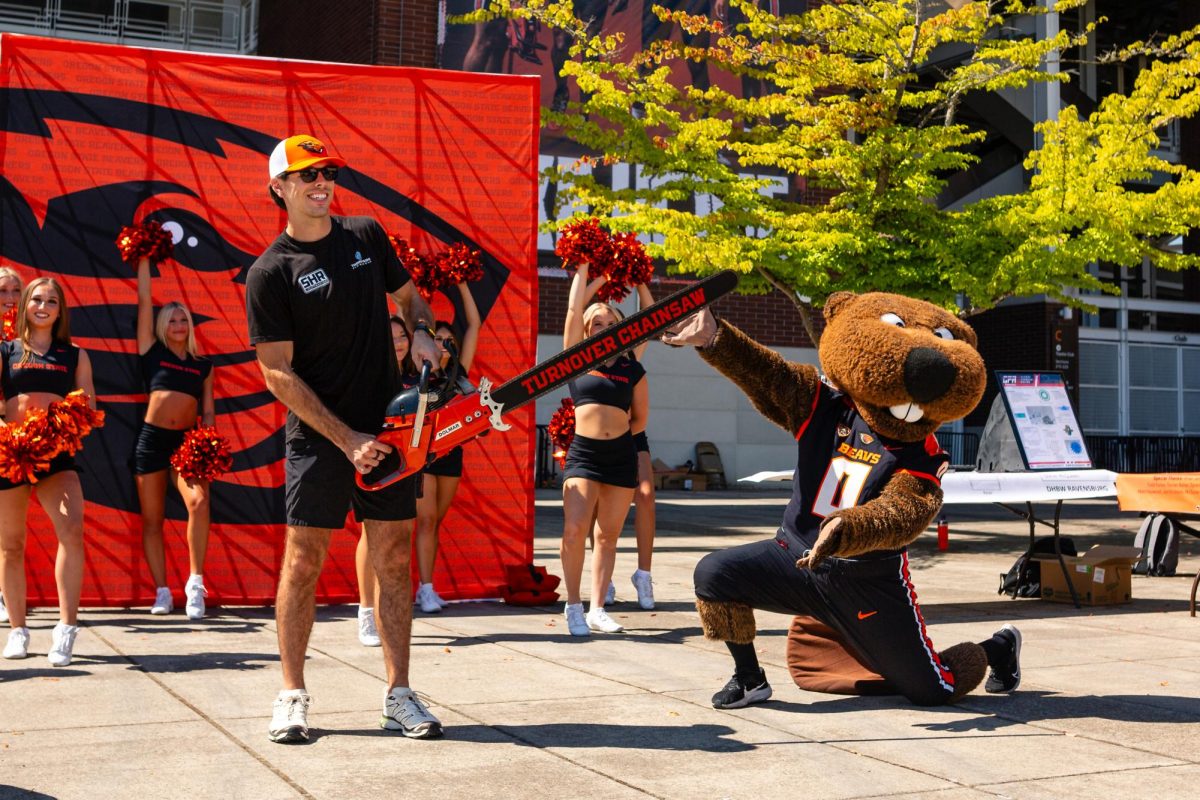 NASCAR driver Dean Thompson having fun with Benny the Beaver outside of Reser Stadium in Corvallis on Aug 29, 2025. Thompson will be racing with an Oregon State University sponsored car tomorrow in Portland, Aug 30.