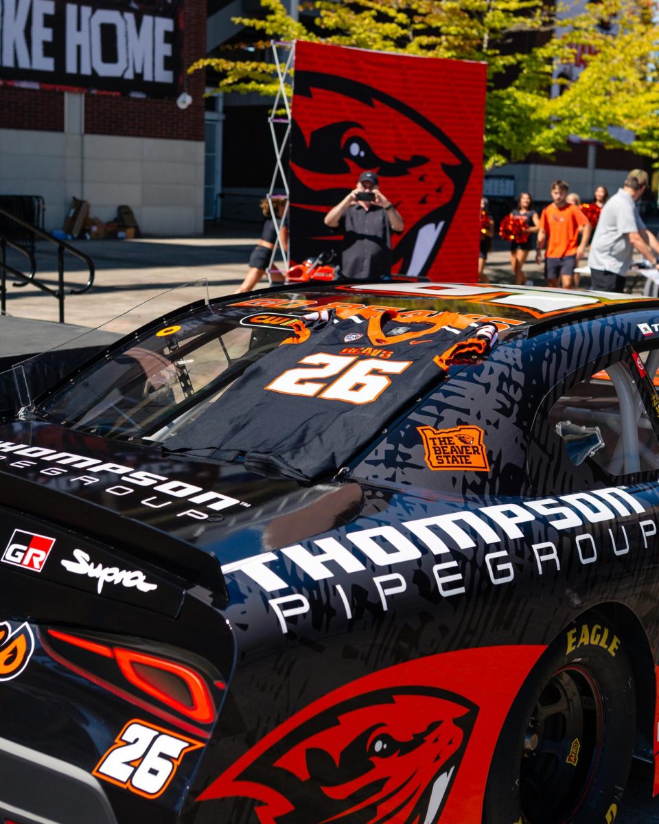 NASCAR driver Dean Thompson was gifted an Oregon State Football jersey in front of Reser Stadium in Corvallis on Aug 29, 2025. The car was on display ahead of tomorrow's race in Portland on Aug 30.