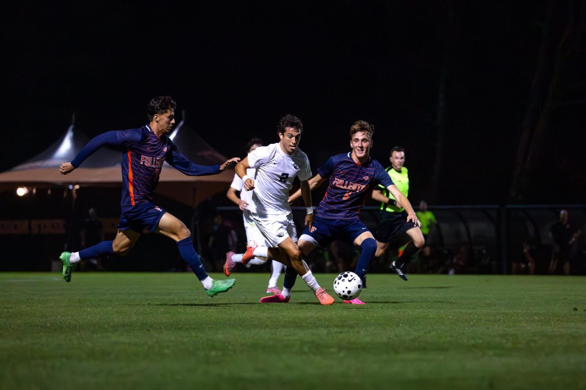 OSU defender Iker Carbonell Garcia maneuvers past two Fullerton defenders on Thursday to continue moving downfield. Oregon State beat Fullerton 4-2 at Lorenz Field in Corvallis on Sept. 4, 2025.