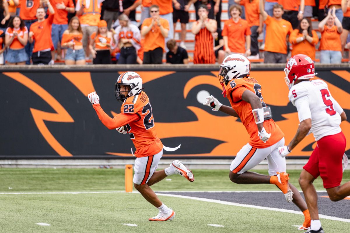 Defensive back Jalil Tucker (22) intercepts the ball in the end zone at the game against Fresno State University on Sept. 6, at Reser Stadium. Tucker ran the ball to the 41 yard line.