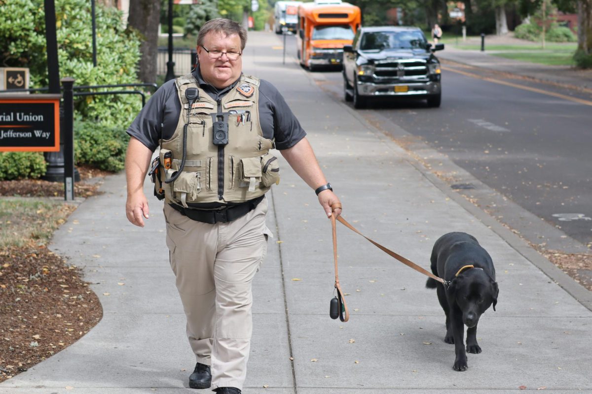 Campus safety officer Patrick Sloma and campus therapy dog Cedar walking outside the MU on
September 9. Cedar’s job is to provide emotional support to both students and staff.