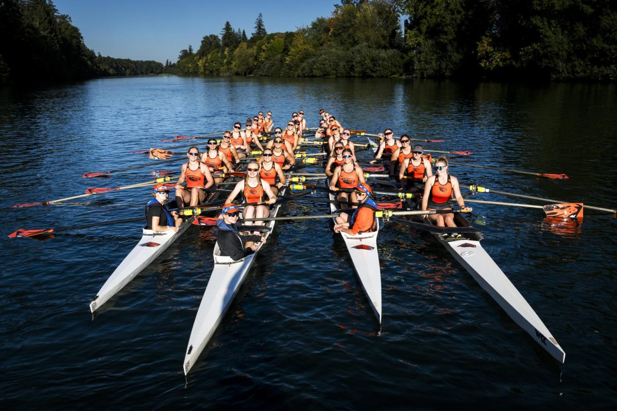 Women's rowing team poses their four boats for a picture. The Orange and Black Regatta takes place on the Willamette River on Nov. 8.