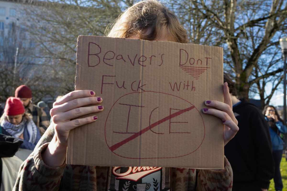 Oregon State University student who preferred not to be identified holds sign reading “Beavers Dont Fuck With ICE” during the ICE Walkout outside of the Benton County Courthouse in Corvallis on Jan. 16.